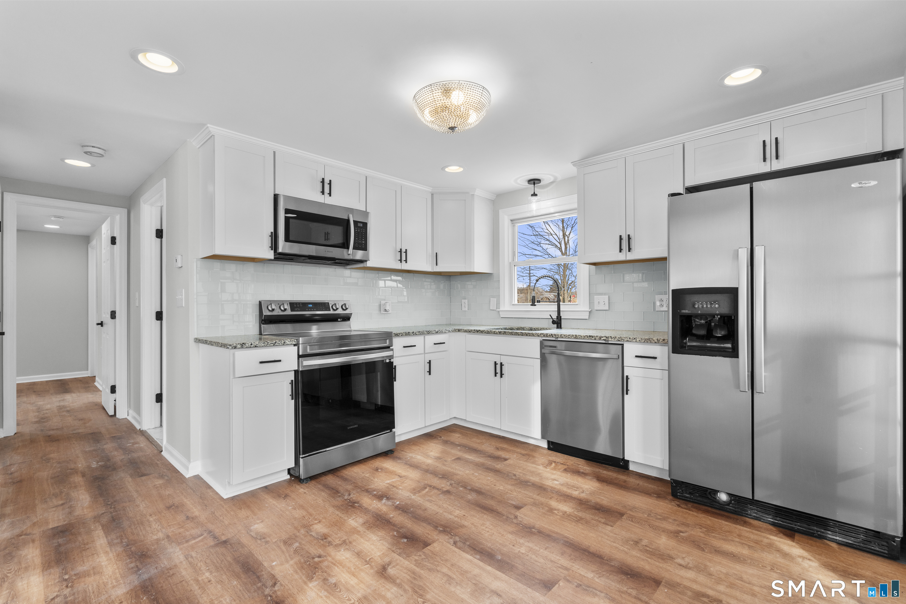 244 Curtiss Street Southington, CT 06489 - Photo 13 of 37 a kitchen with stainless steel appliances granite countertop a refrigerator a stove a sink and a microwave