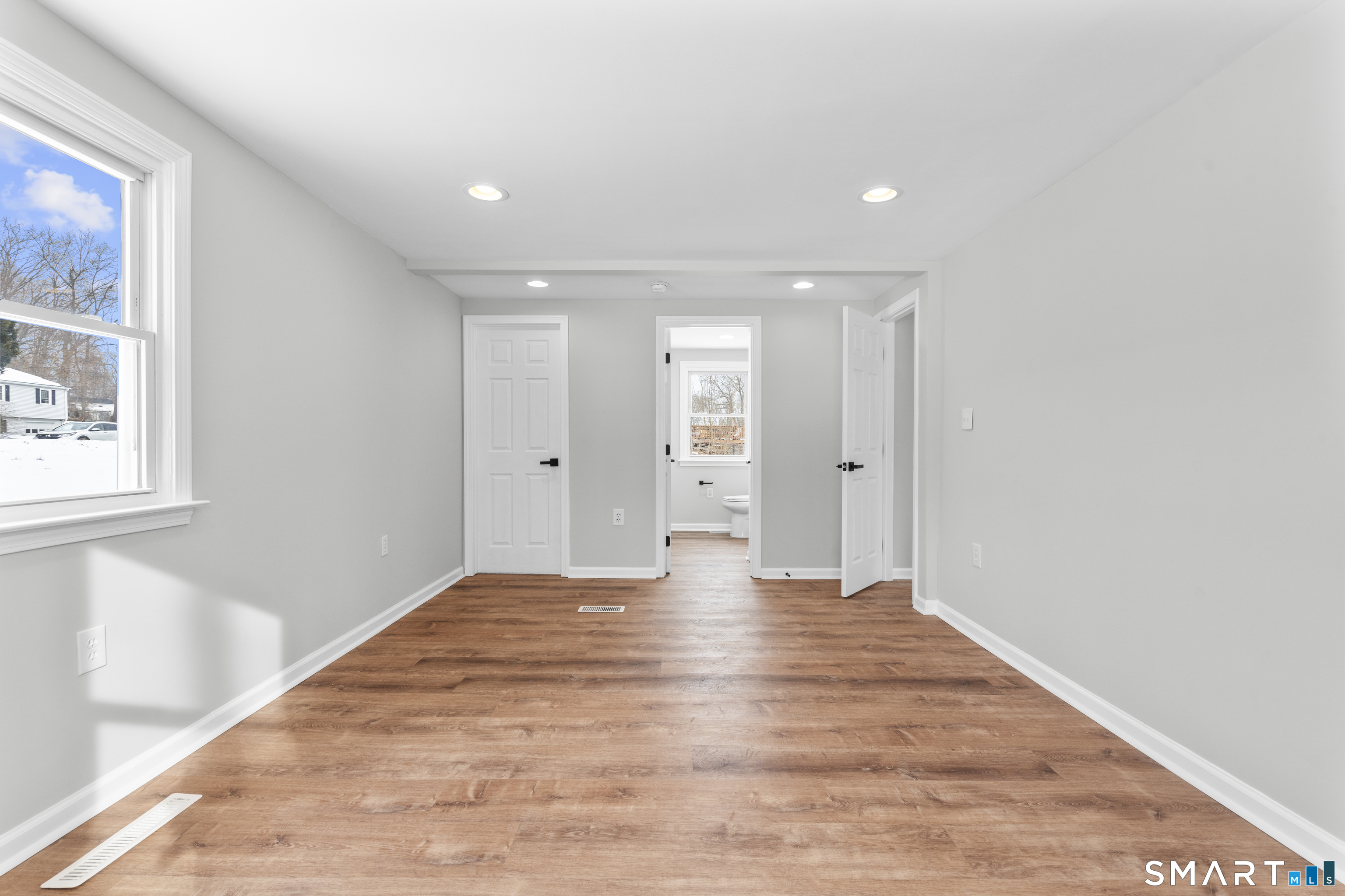 244 Curtiss Street Southington, CT 06489 - Photo 20 of 37 a view of an empty room with wooden floor and a window