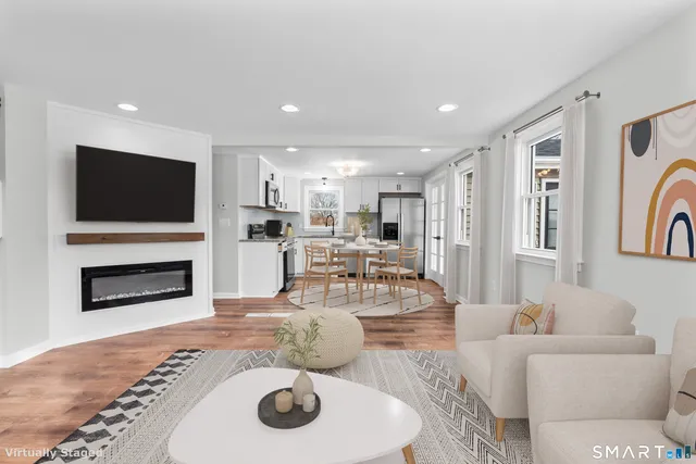a living room with fireplace furniture and a flat screen tv