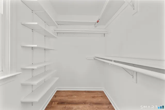 a view of walk in closet with empty racks