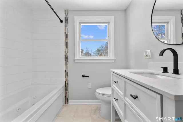 a bathroom with a sink a toilet and a bathtub