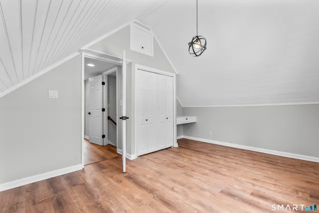 a view of a room with wooden floor and white walls