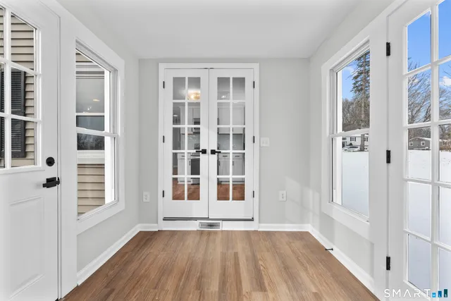 wooden floor in an empty room with a window