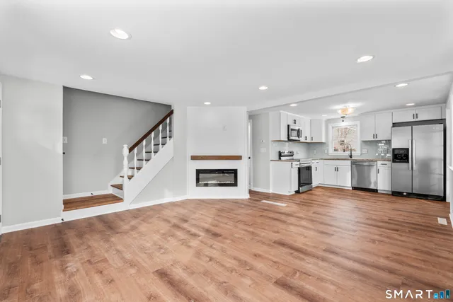 a view of a kitchen with kitchen island wooden floor and window
