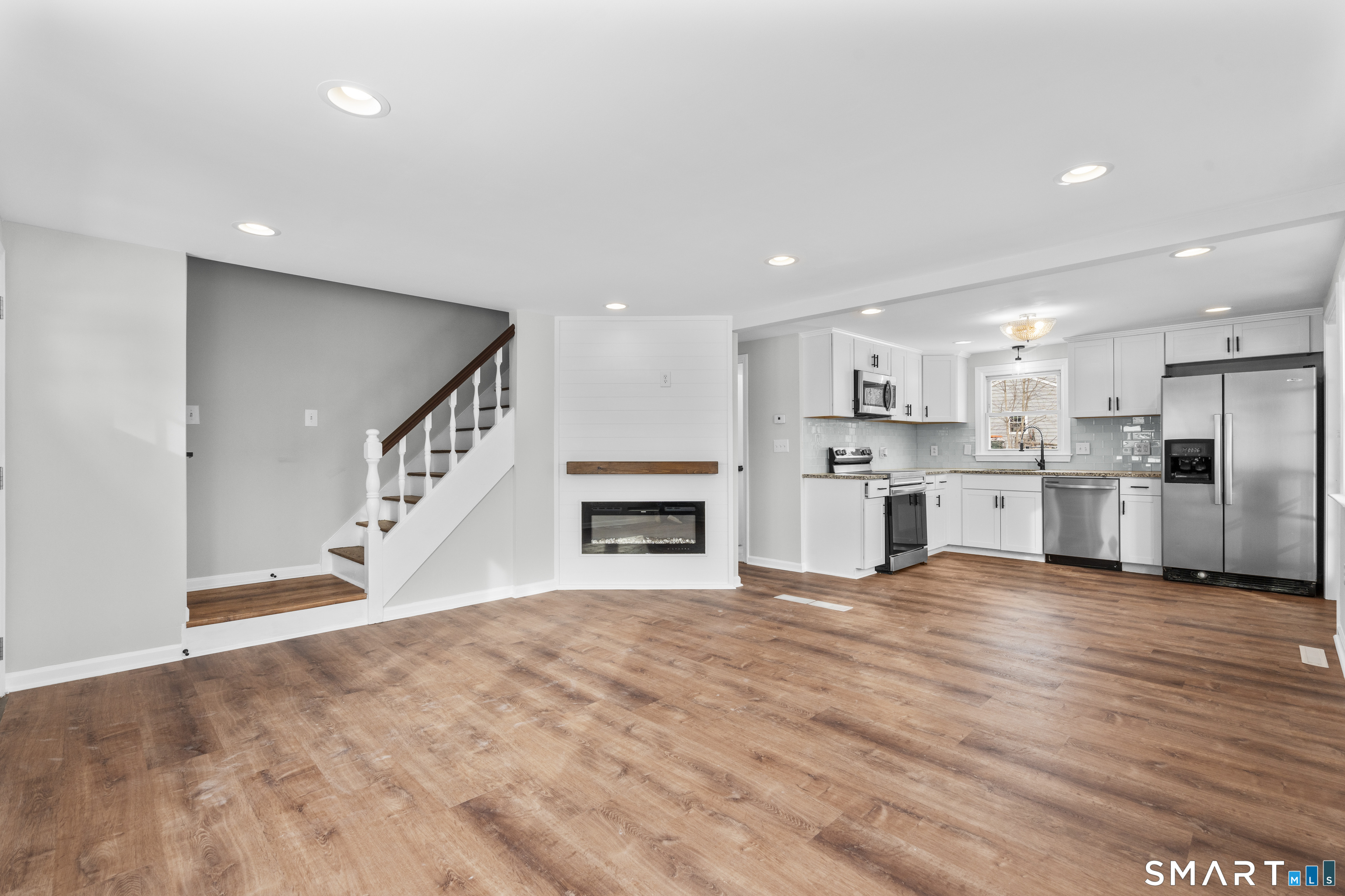 244 Curtiss Street Southington, CT 06489 - Photo 8 of 37 a view of a kitchen with kitchen island wooden floor and window