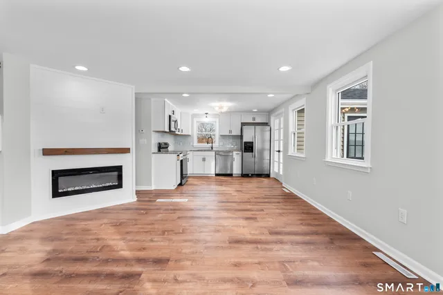 a view of a kitchen with a sink and a fireplace
