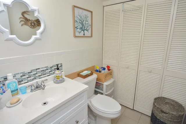 a bathroom with a sink a toilet and a mirror