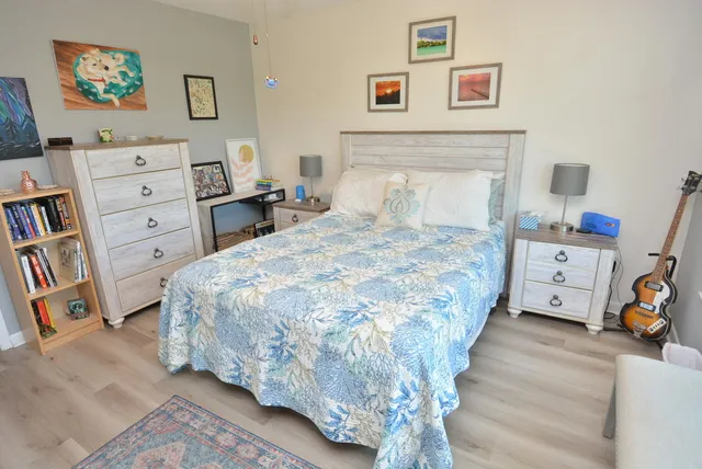 a bedroom with a bed and a dresser