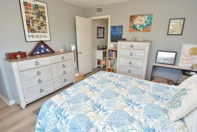 a bedroom with a bed and a large window