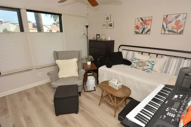 a bedroom with furniture and wooden floor