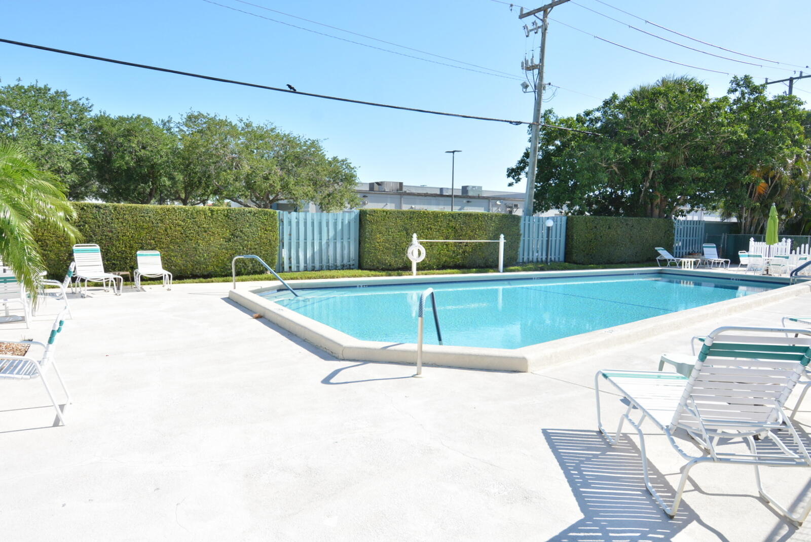 950 South Kanner Highway, Unit TH9 Stuart, FL 34994 - Photo 47 of 51 a swimming pool with outdoor seating and yard