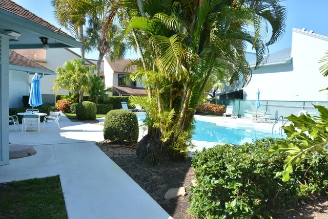 a view of a back yard of the house with a garden