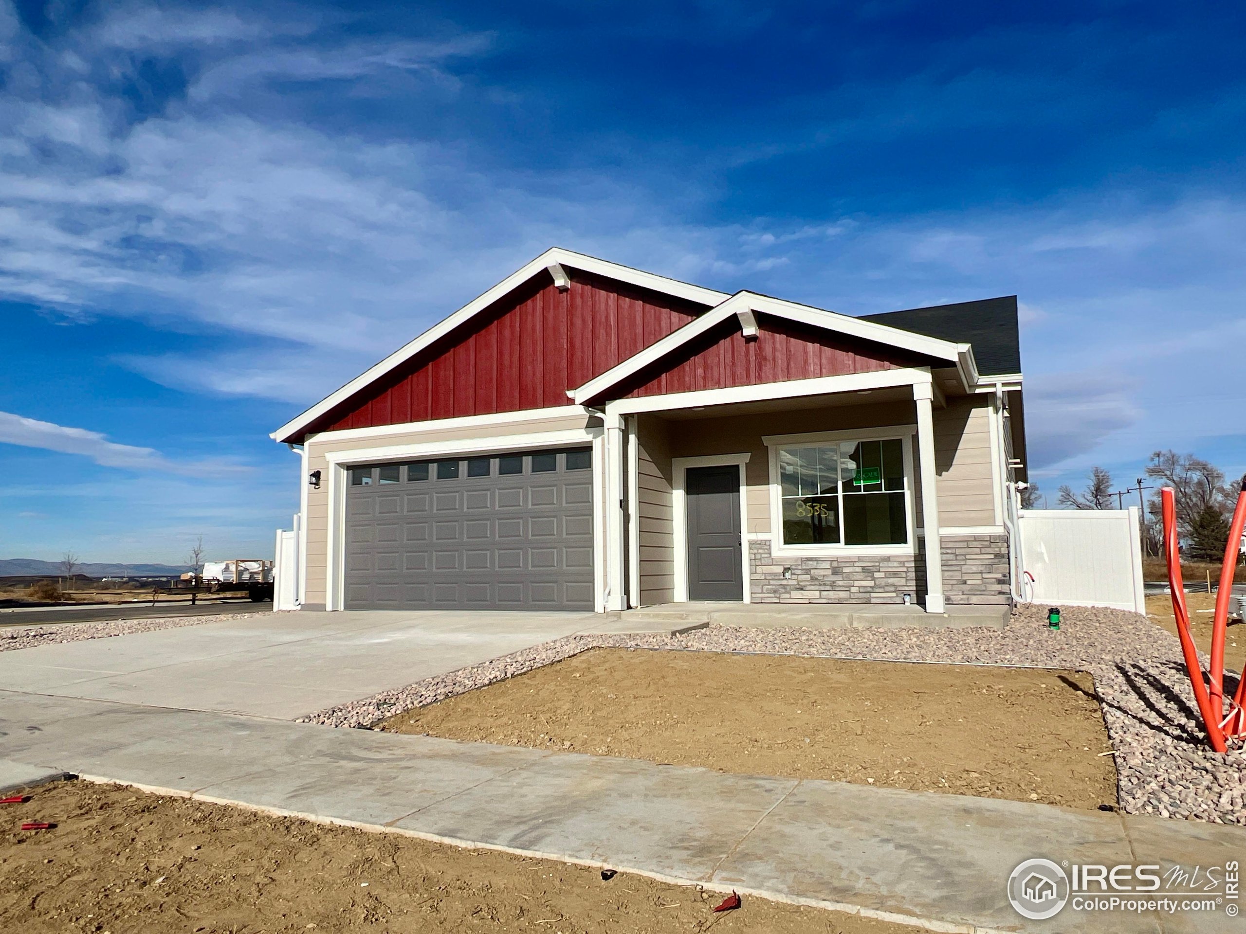8535 West 5th Street Greeley, CO 80634 - Photo 2 of 12 a front view of a house with a garden