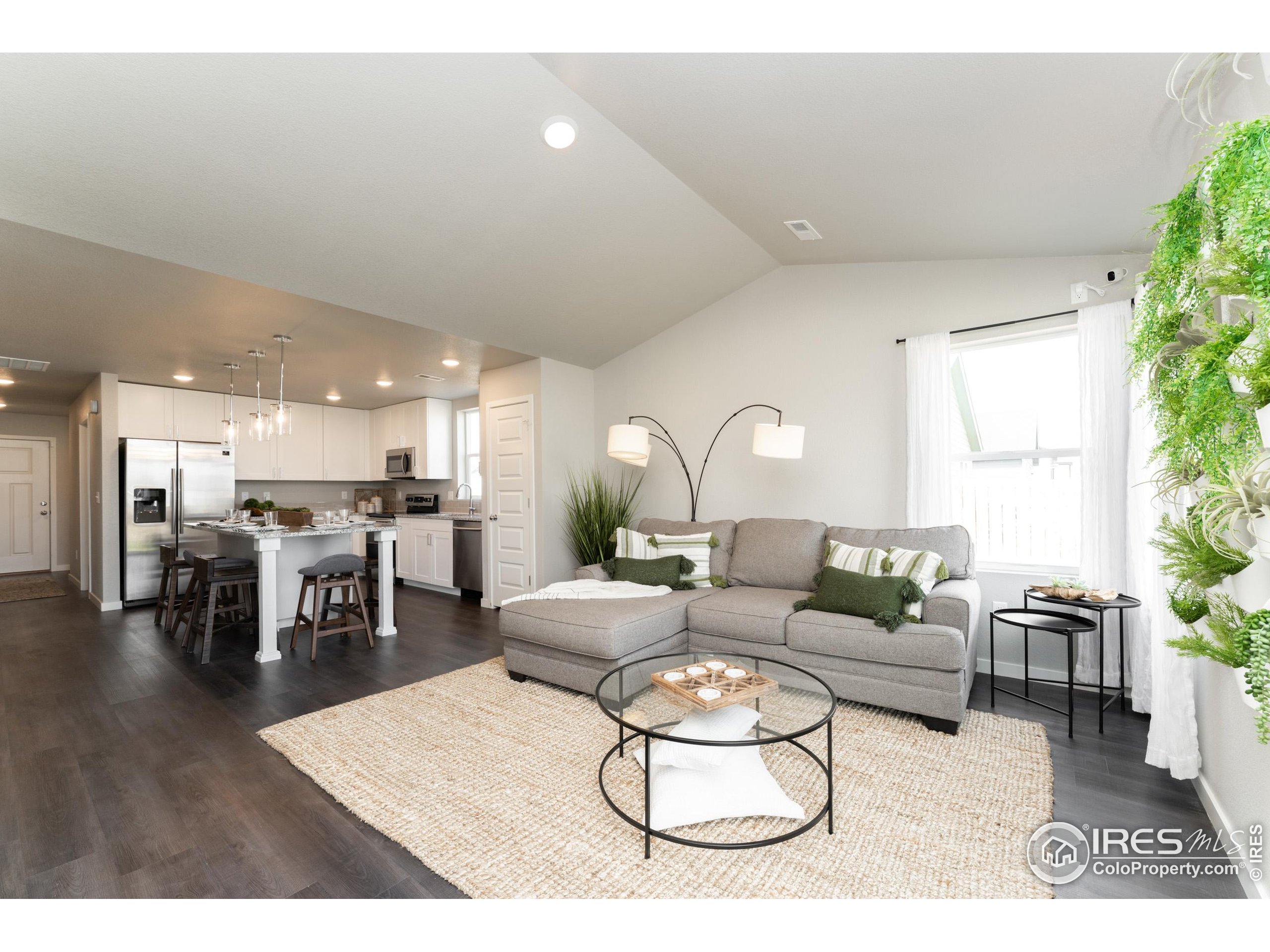 8535 West 5th Street Greeley, CO 80634 - Photo 7 of 12 a living room with furniture kitchen view and a large window