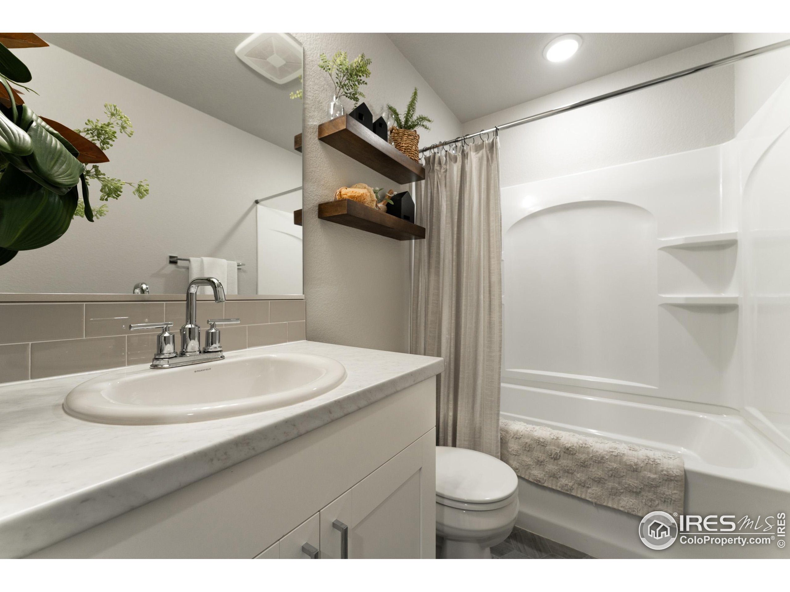 8535 West 5th Street Greeley, CO 80634 - Photo 9 of 12 a bathroom with a sink toilet and shower