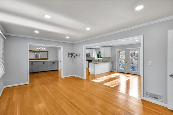 a view of empty room with wooden floor and window