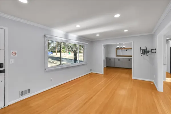 a view of an empty room with a fireplace and a window