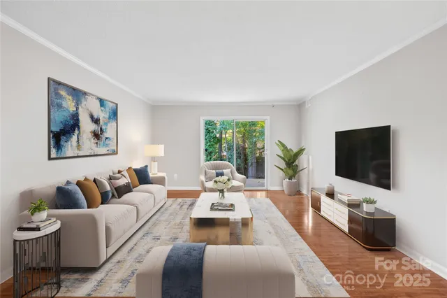 a living room with furniture a flat screen tv and a large window