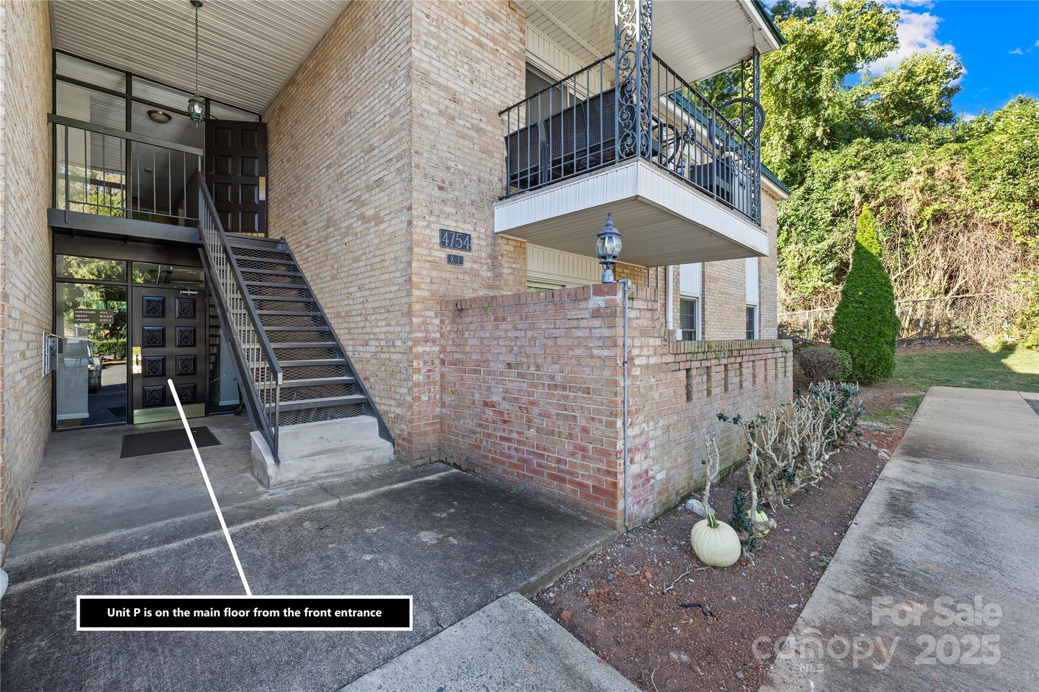 4754 Hedgemore Drive, Unit P Charlotte, NC 28209 - Photo 14 of 19 a front view of a house with a garden