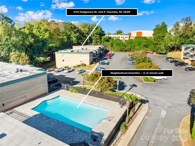 a view of a pool with table and chairs