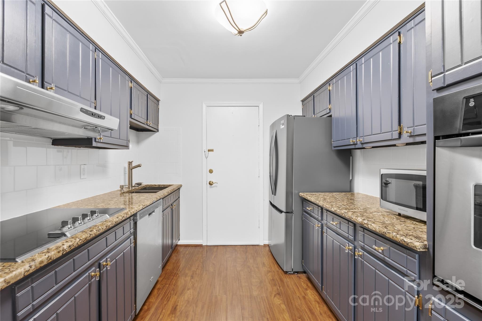 4754 Hedgemore Drive, Unit P Charlotte, NC 28209 - Photo 6 of 19 a kitchen with stainless steel appliances granite countertop a refrigerator a stove and a sink