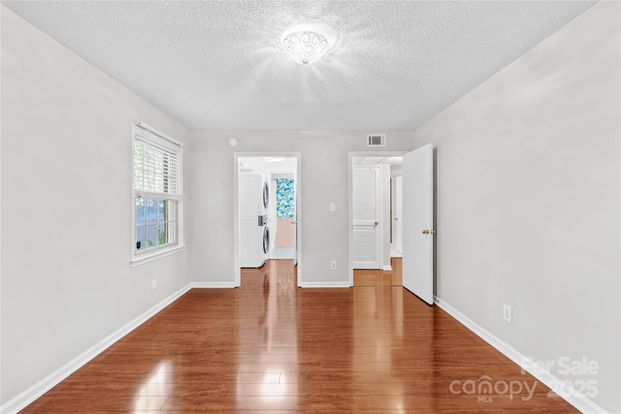 4754 Hedgemore Drive, Unit P Charlotte, NC 28209 - Photo 8 of 19 a view of an empty room with window and wooden floor