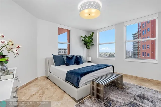 a front view of a multi story residential apartment building with yard and outdoor space