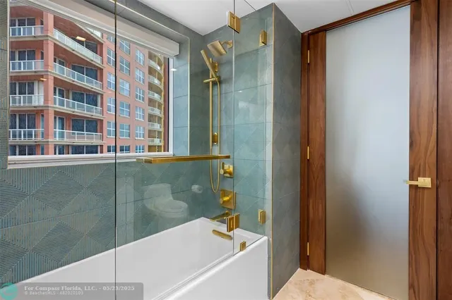 a bathroom with a glass shower door