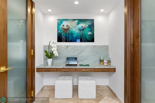 a living room with furniture a large window and a chandelier