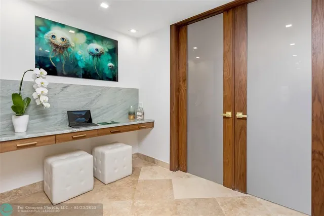 a room with pool table and windows