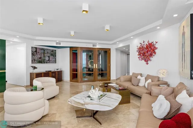 a living room with furniture and a large window