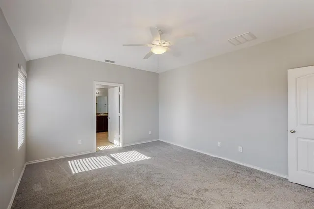 a view of a livingroom with a ceiling fan and window