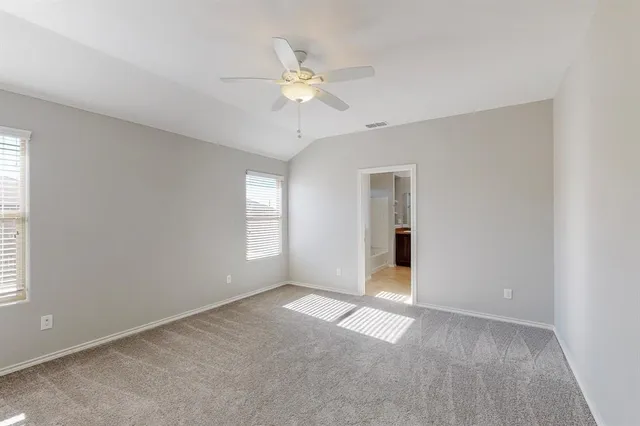 a view of an empty room with a ceiling fan