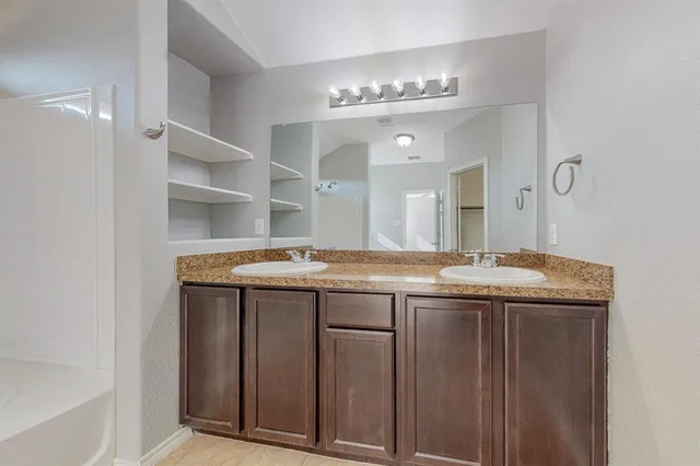 a bathroom with a granite countertop sink a toilet and bathtub