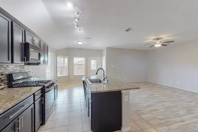 a view of kitchen with cabinets and wooden floor