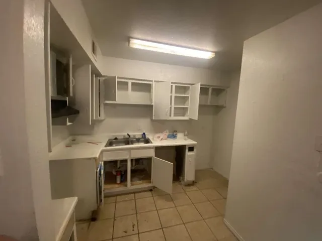 a kitchen with a sink and cabinets