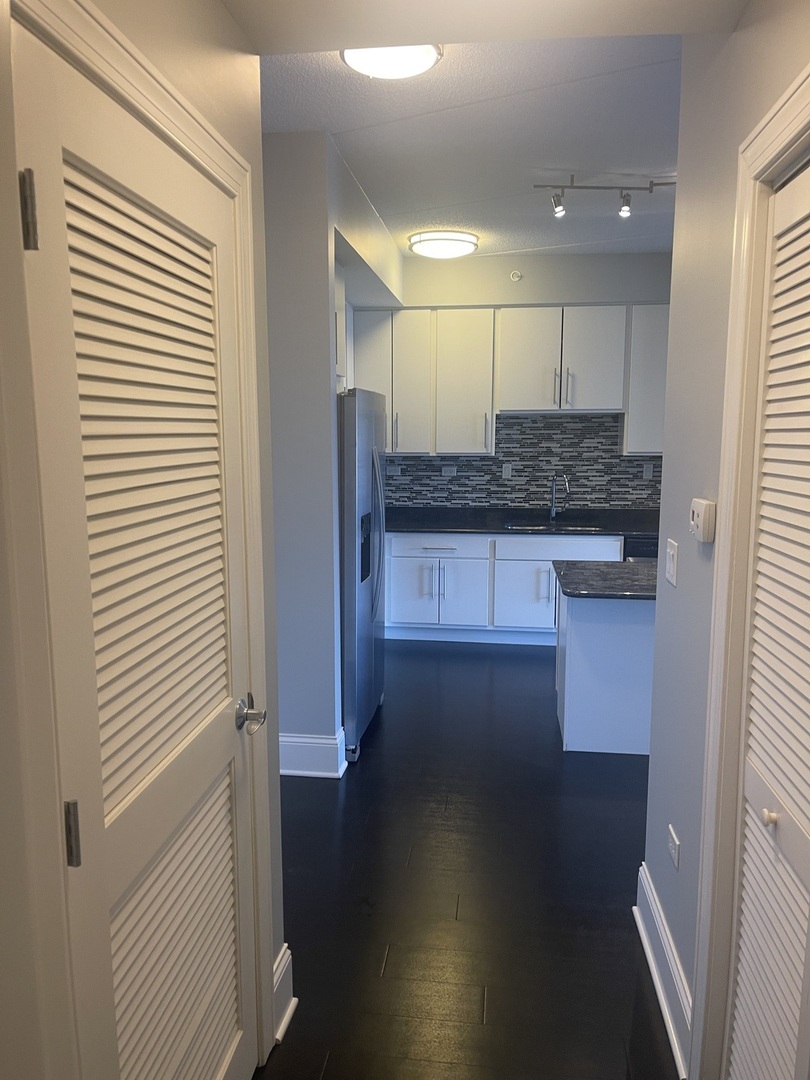 728 North Diamond Lake Road, Unit 211 Mundelein, IL 60060 - Photo 12 of 17 a kitchen with a sink and a refrigerator