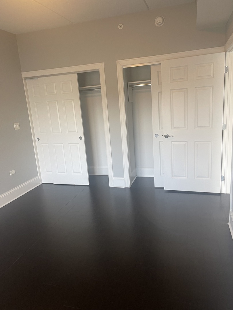 728 North Diamond Lake Road, Unit 211 Mundelein, IL 60060 - Photo 16 of 17 a view of a small space with wooden floor and closet area