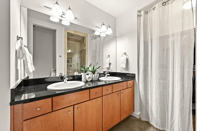 a bathroom with a double vanity sink and a mirror