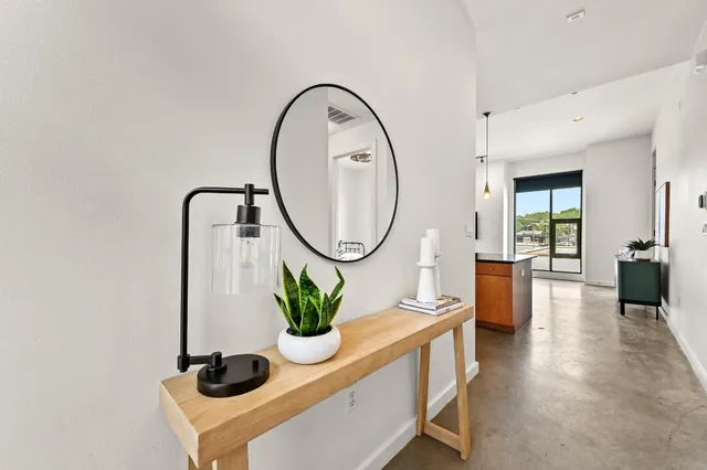 a dining room with furniture and a potted plant