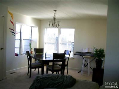 1945 Piner Road, Unit 100A Santa Rosa, CA 95403 - Photo 4 of 12 a view of a dining room with furniture window and outside view