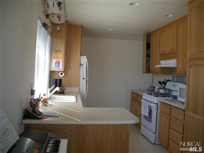 1945 Piner Road, Unit 100A Santa Rosa, CA 95403 - Photo 5 of 12 a kitchen with a sink stove and cabinets
