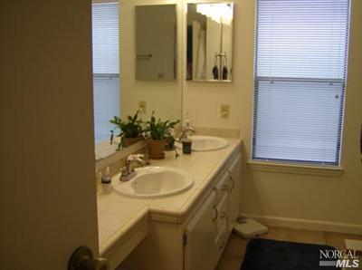 1945 Piner Road, Unit 100A Santa Rosa, CA 95403 - Photo 10 of 12 a bathroom with a sink and a mirror
