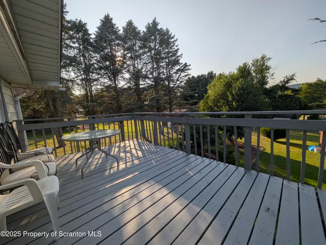 a view of balcony with wooden floor and outdoor seating