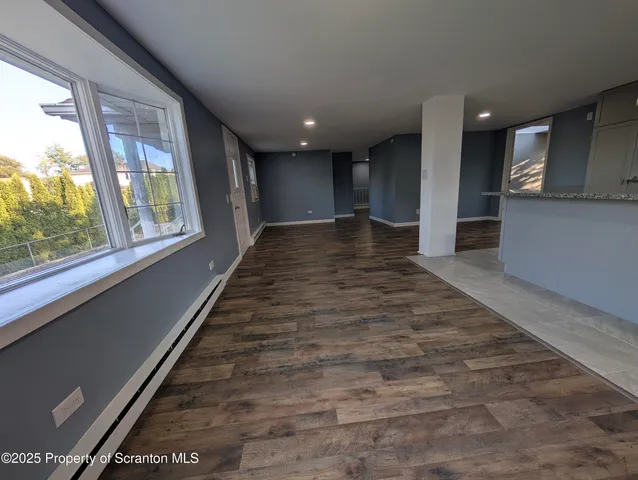 a view of gallery with wooden floor