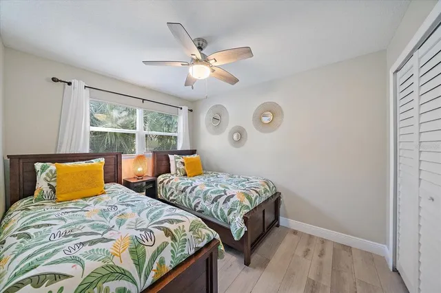 a bedroom with two beds and a window