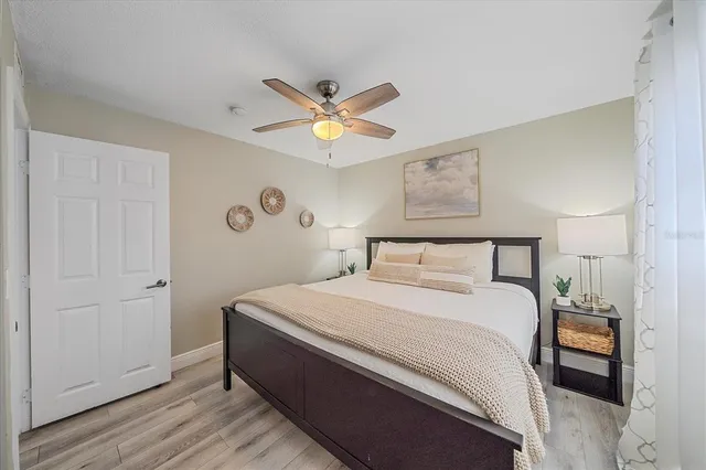 a bedroom with a bed and a ceiling fan