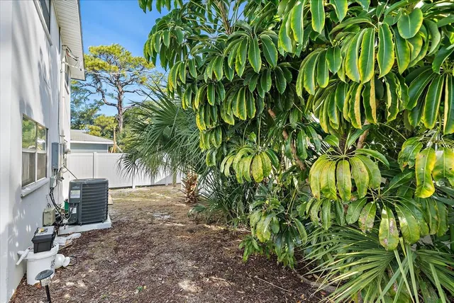 a view of backyard with plants and outdoor seating