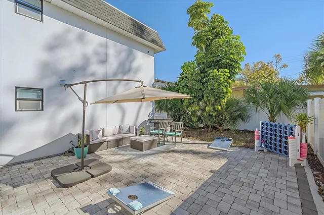 a backyard of a house with table and chairs