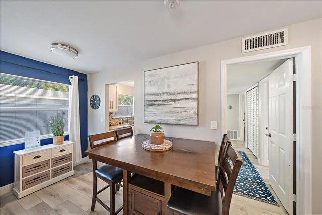 a view of a dining room with furniture window and wooden floor